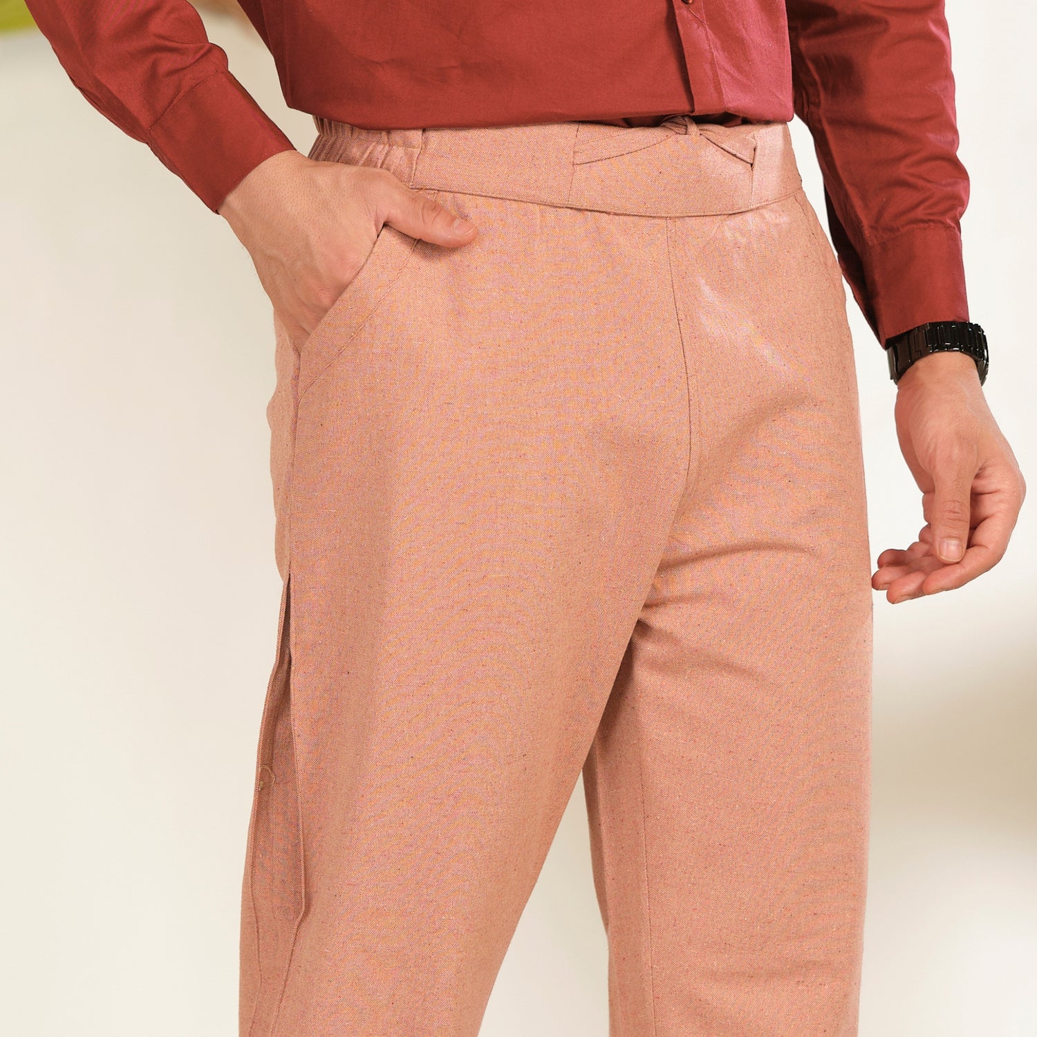 Salmon peach relaxed fit cotton linen texture trousers for men by Marra Roya